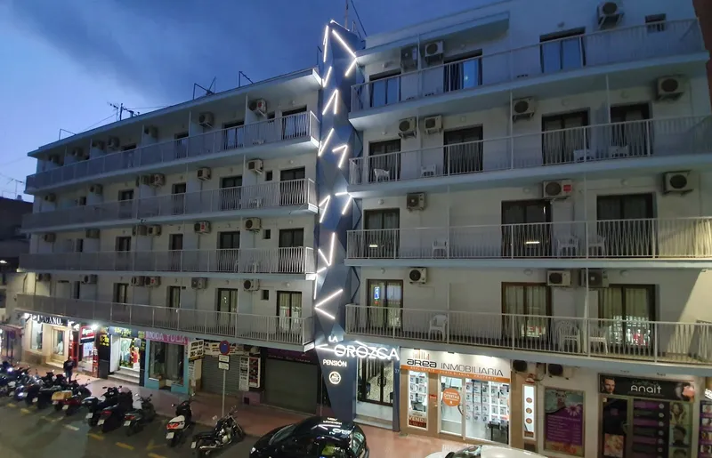La Orozca: The building at dusk, Lit sign on the street front at dusk