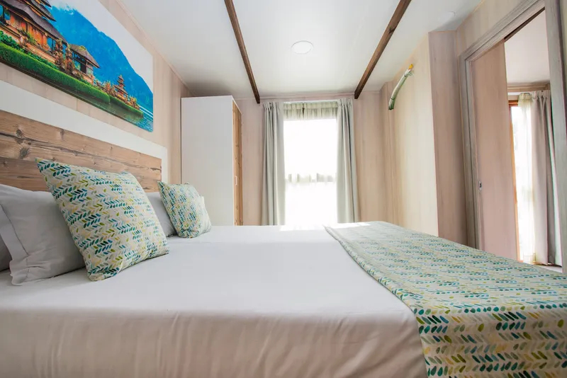 Magic Natura: Bedroom, Double bed with patterned cushions and wooden beams