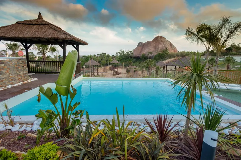 Magic Natura: Garden pool, Pool framed by tropical planting and a gazebo