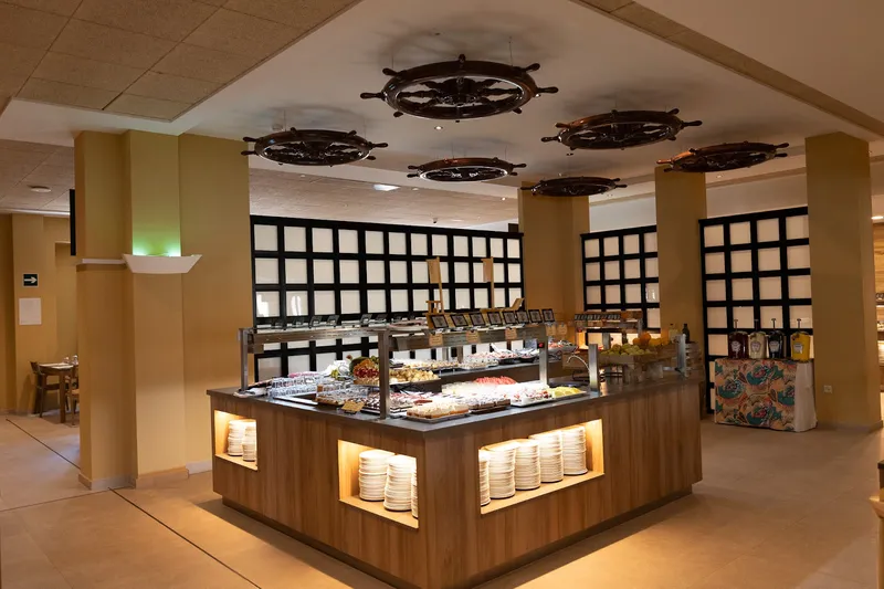 Magic Pirates: Buffet, Lit buffet island under ship's wheel chandeliers