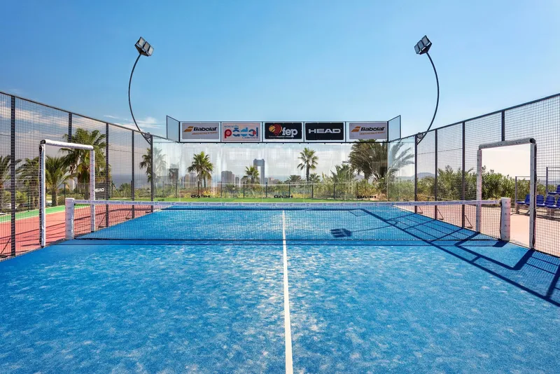 Villaitana: Padel court, Blue glass-walled padel court with floodlights