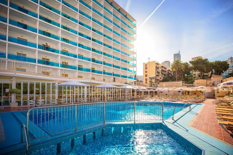 Nereo: Pool and hotel, Pool with loungers and parasols below the hotel tower