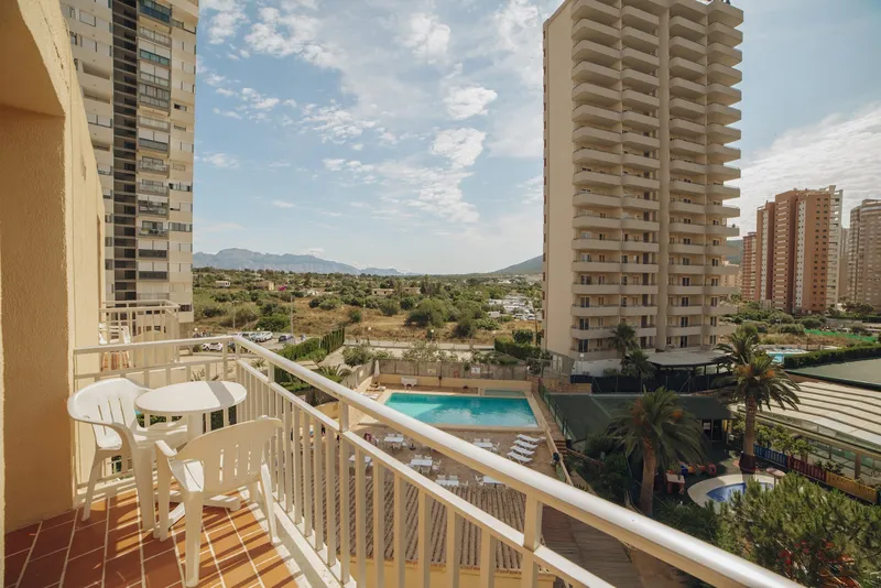 Palm Court: Balcony view, Balcony with table over the pool and hills