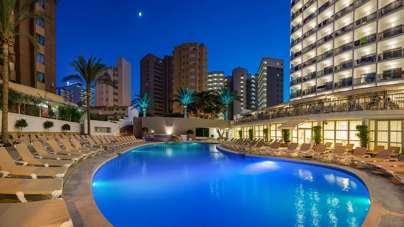 RH Princesa: Pool at dusk, Lit pool with loungers below the hotel