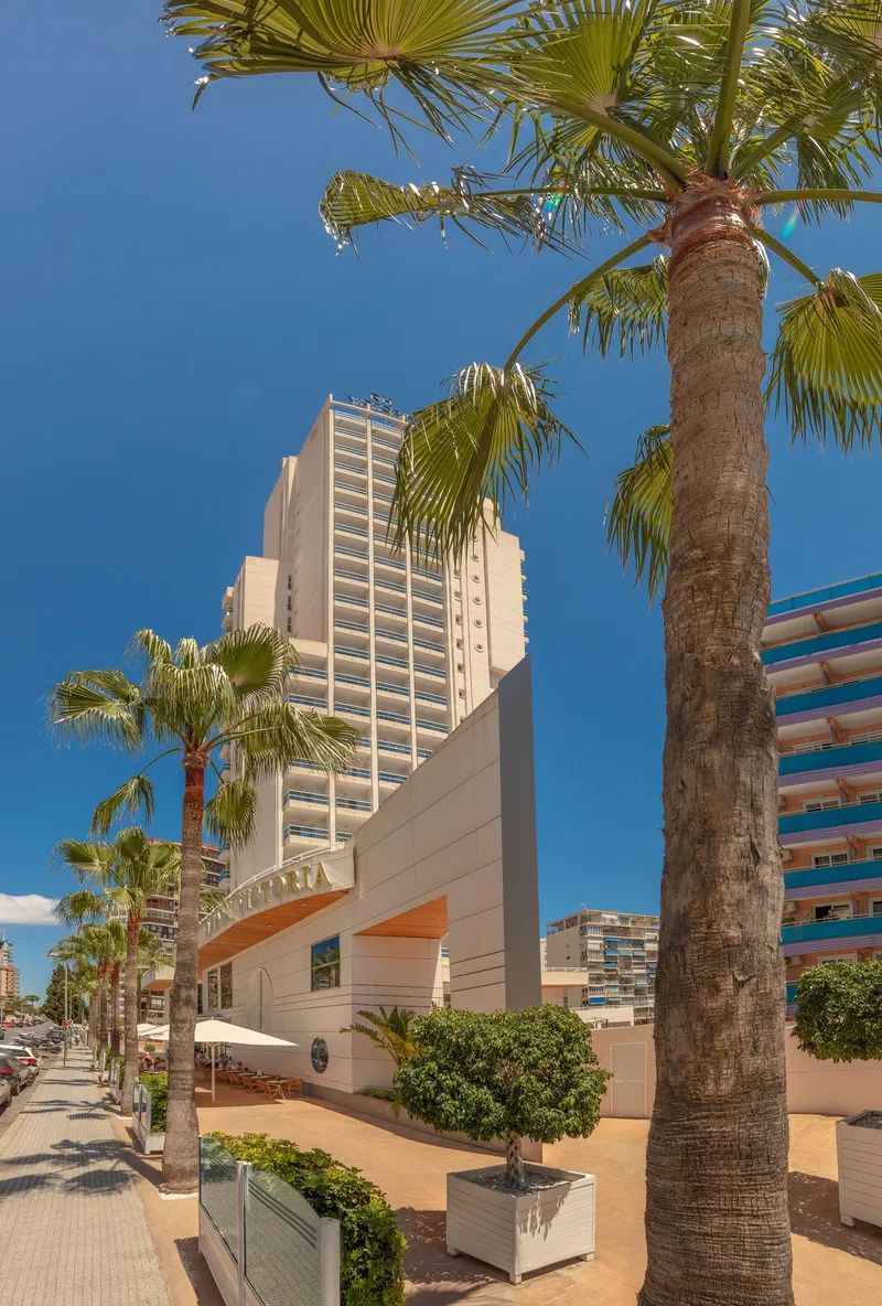 RH Victoria: Street view, Hotel building seen through palm trees from the street