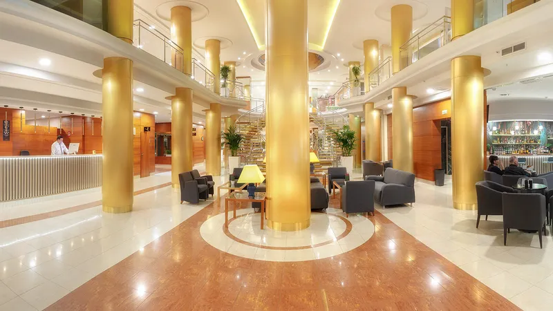 RH Victoria: Lobby, Lobby with gold columns, armchairs, reception and bar
