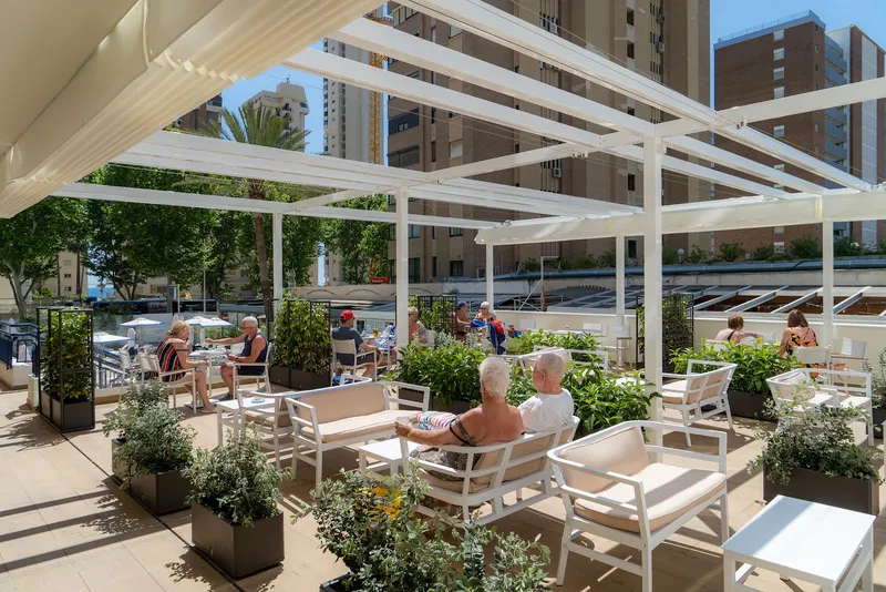 Riudor: Terrace, Pergola terrace with white chairs and planters