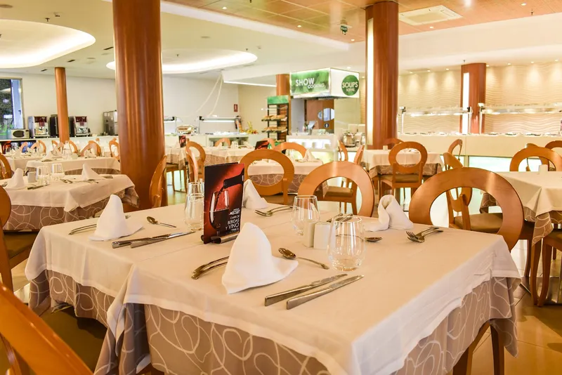 Riviera: Restaurant, Dining room with set tables and wooden chairs
