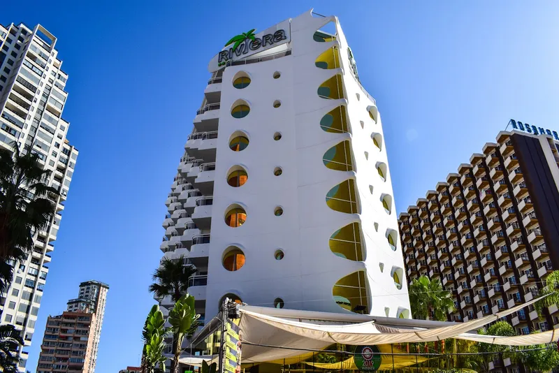 Riviera: The hotel, White hotel tower with round windows on a clear day
