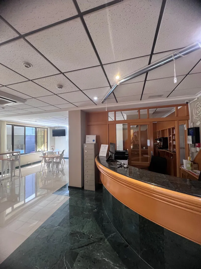 Rosabel: Lobby, Marble-floored lobby with curved wooden desk