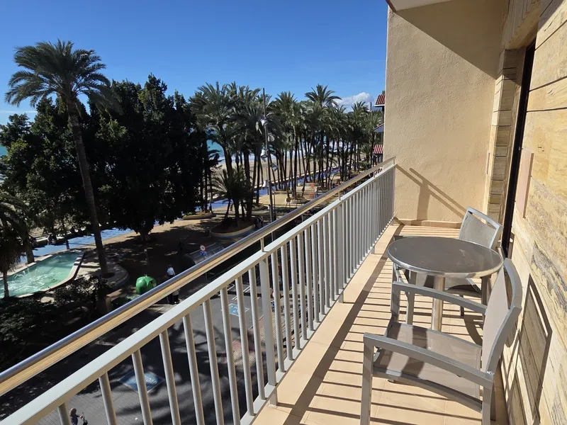 Tanit: Balcony, Balcony with table and chairs over palms and sea