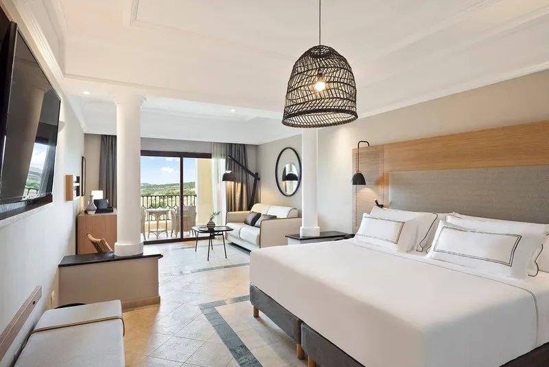 The Level: Double room, Large bed, sofa and balcony doors in a bright room