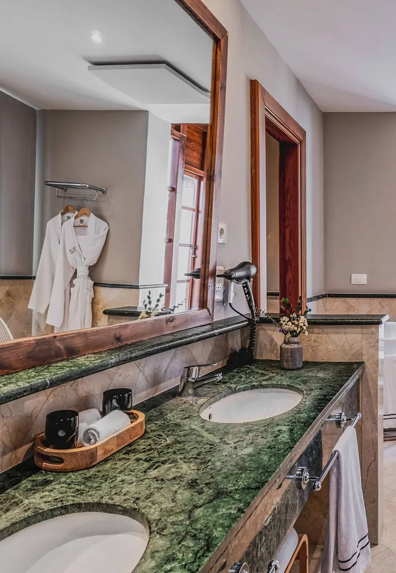 The Level: Bathroom, Double basin with green marble top and bathrobes