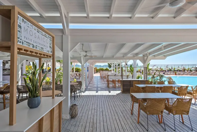 The Level: Terrace restaurant, Covered deck with rattan chairs looking towards the pool