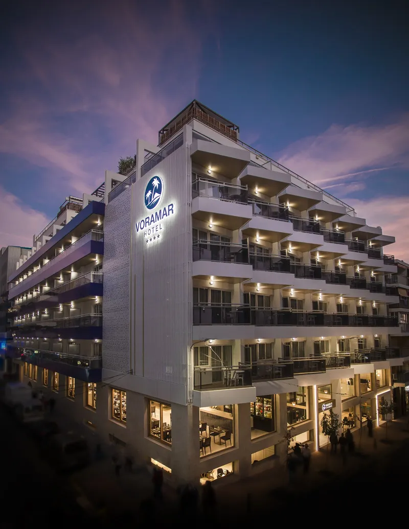 Voramar: The hotel at dusk, Hotel facade with lit balconies and Voramar sign at dusk