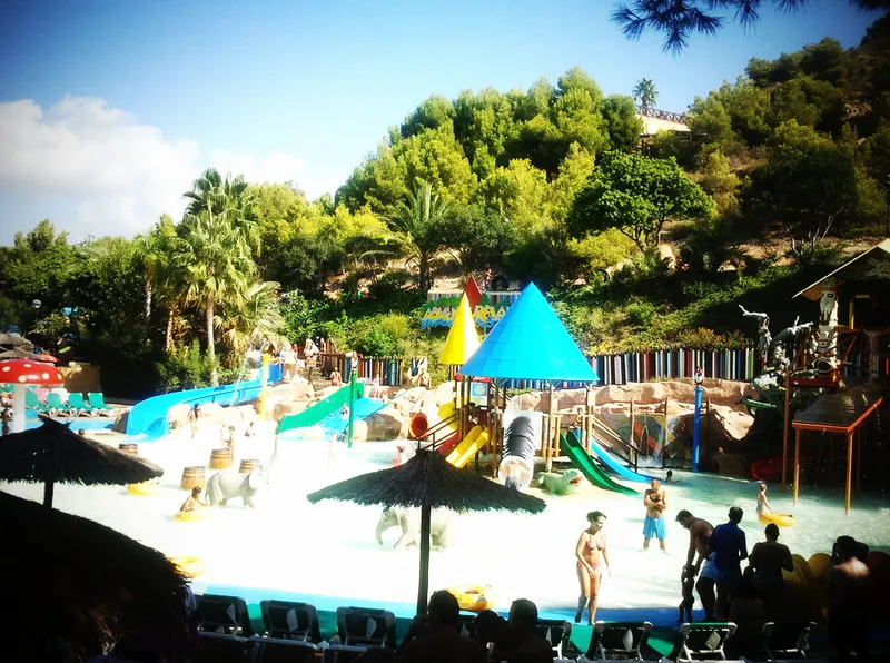 A busy September day: Pools, parasols and slides on the hillside