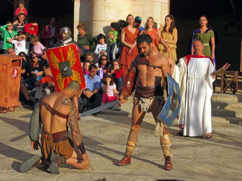Gladiators in Rome: A street show with families sitting on the steps to watch