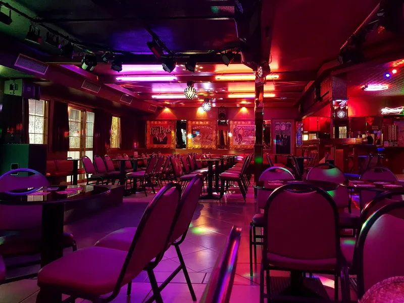 Inside a Benidorm show bar: stage lights, red chairs and an empty dance floor before the crowd